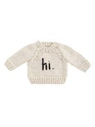 Cream sweater with long sleeves and "hi." printed in black on the front.