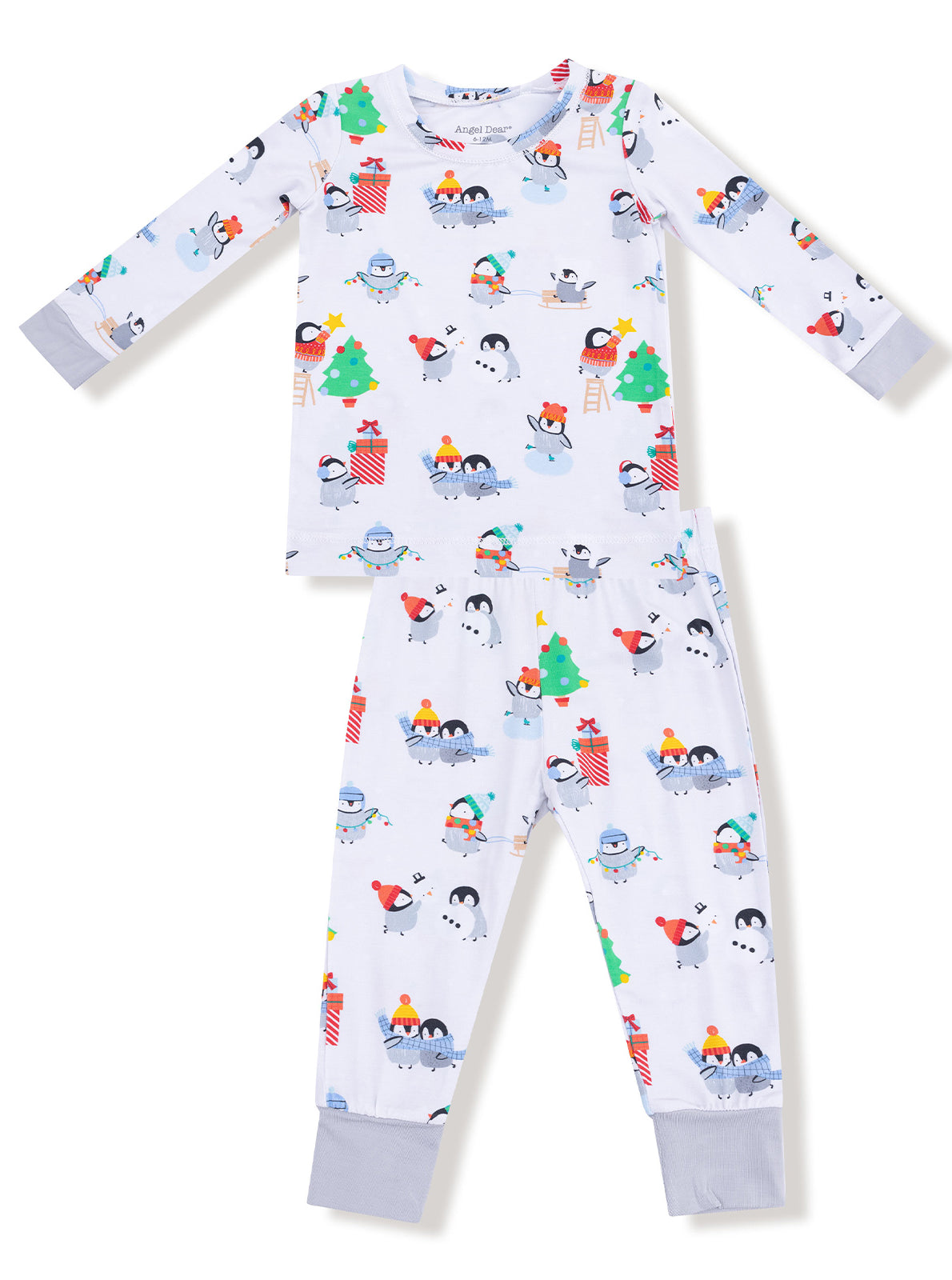 Children's winter pajamas featuring cute penguins, snowmen, and festive decorations on a light background.