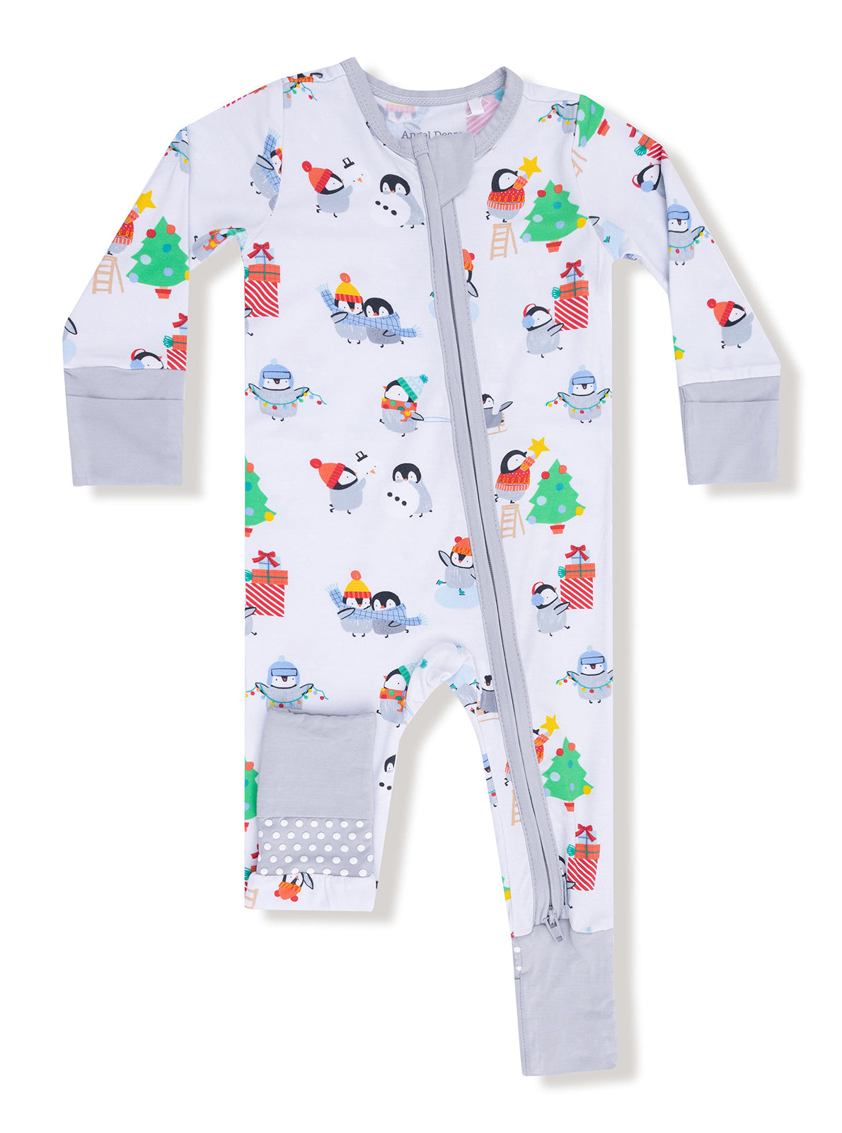Child's festive pajama onesie with penguins, snowmen, and Christmas trees in cheerful colors.