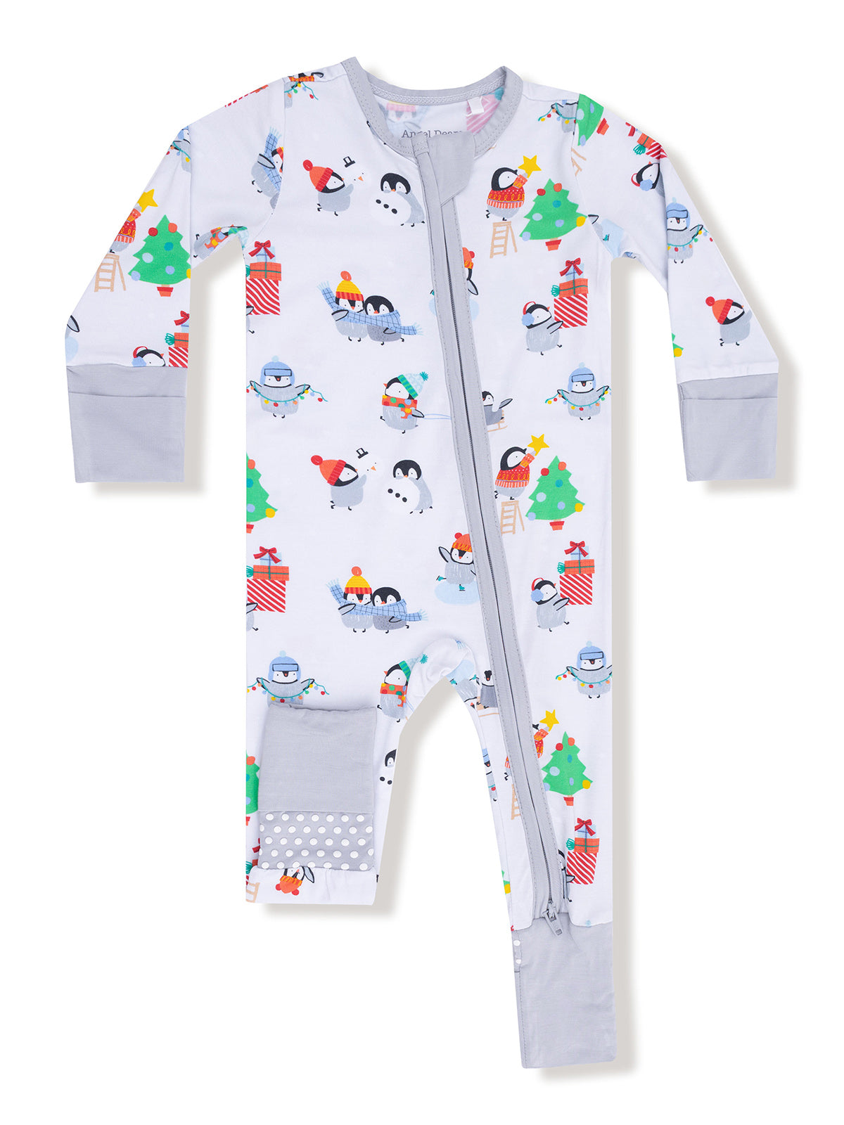 Child's festive pajama onesie with penguins, snowmen, and Christmas trees in cheerful colors.