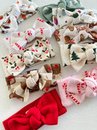 Colorful fabric headbands in various festive patterns, including Christmas motifs and textured designs.