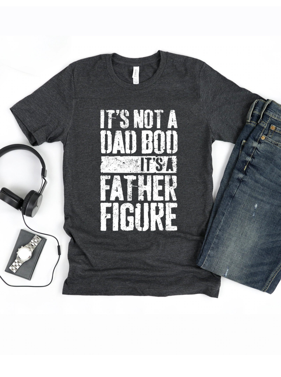 Gray t-shirt with text "It's not a dad bod, it's a father figure," styled with headphones and jeans.