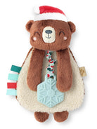 Soft plush bear toy wearing a Santa hat, with colorful tags and a blue snowflake teether attached.