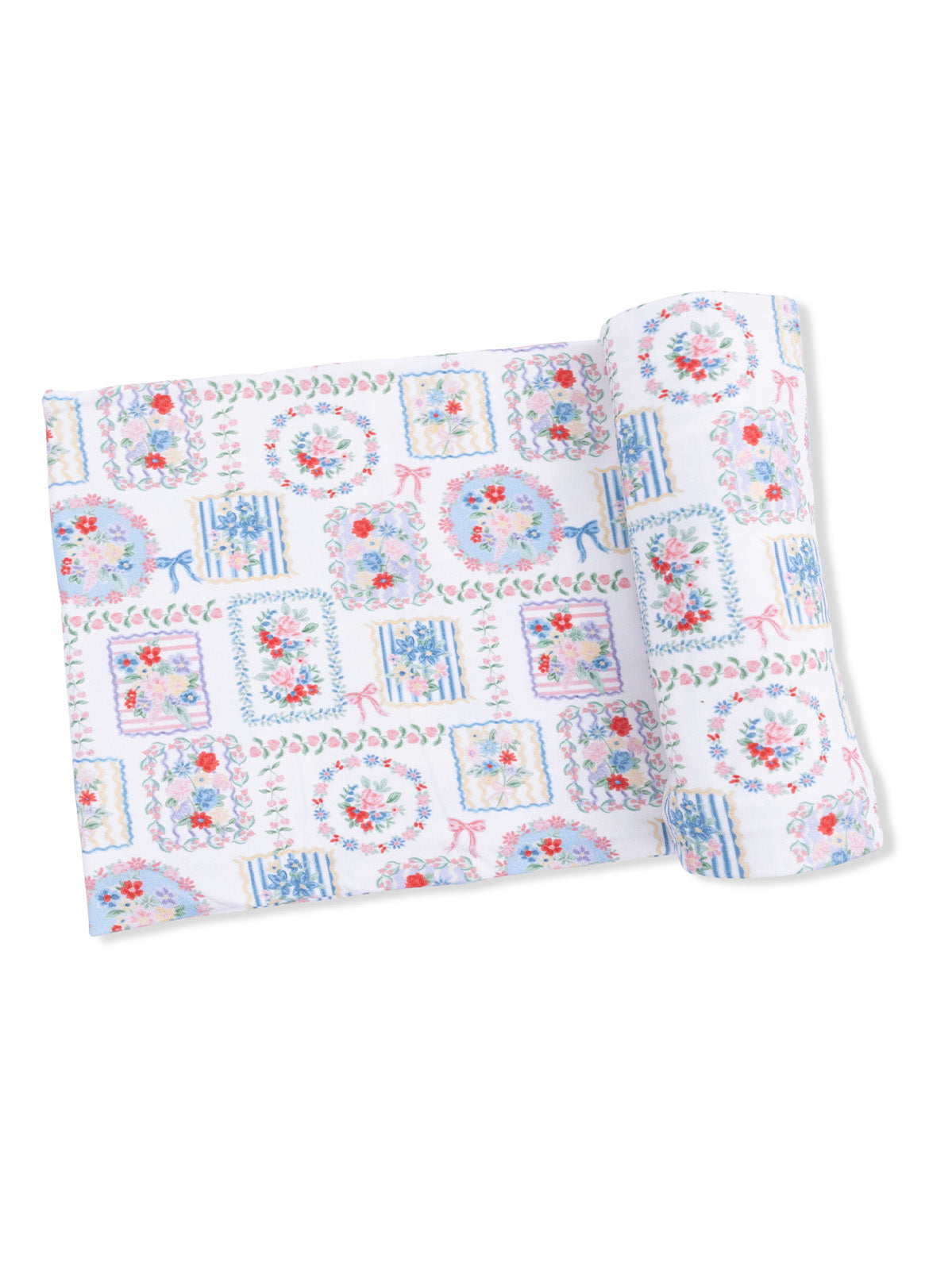 Colorful floral patterned fabric rolled up, featuring pastel hues and decorative motifs.