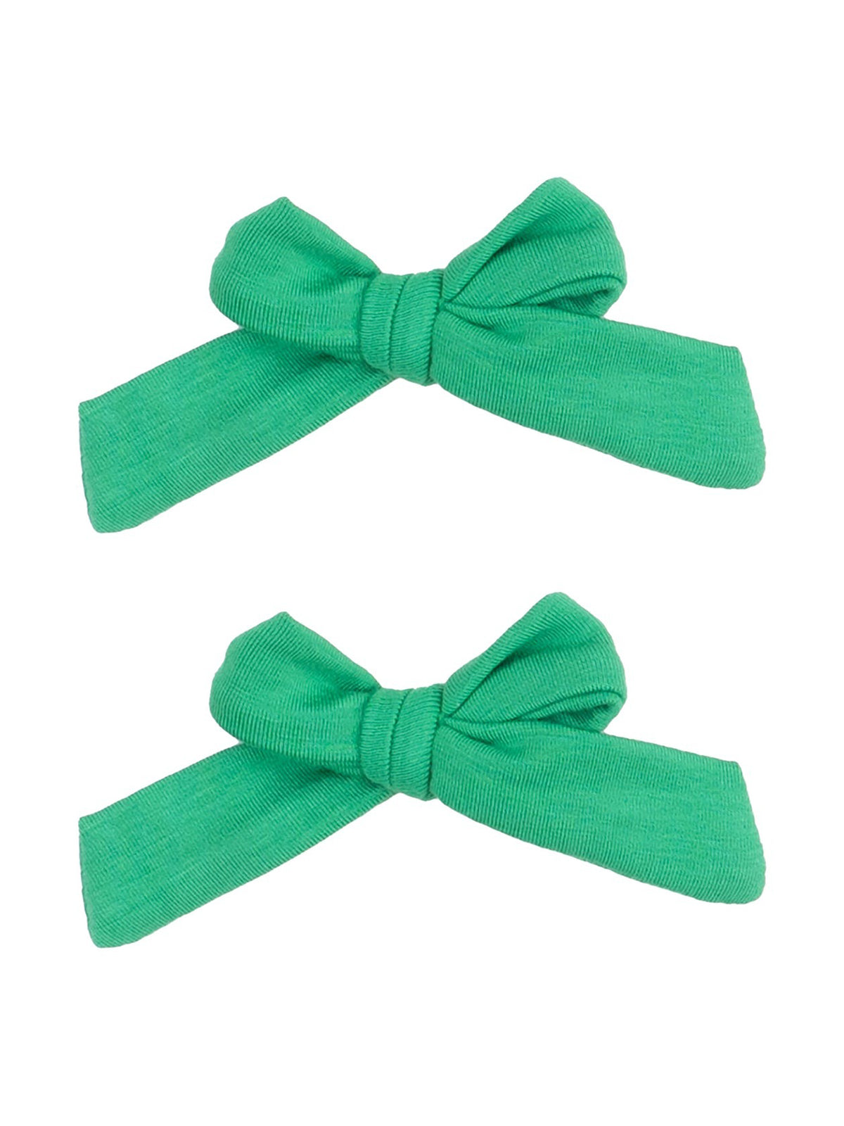 Two green fabric hair bows laid flat on a white background.