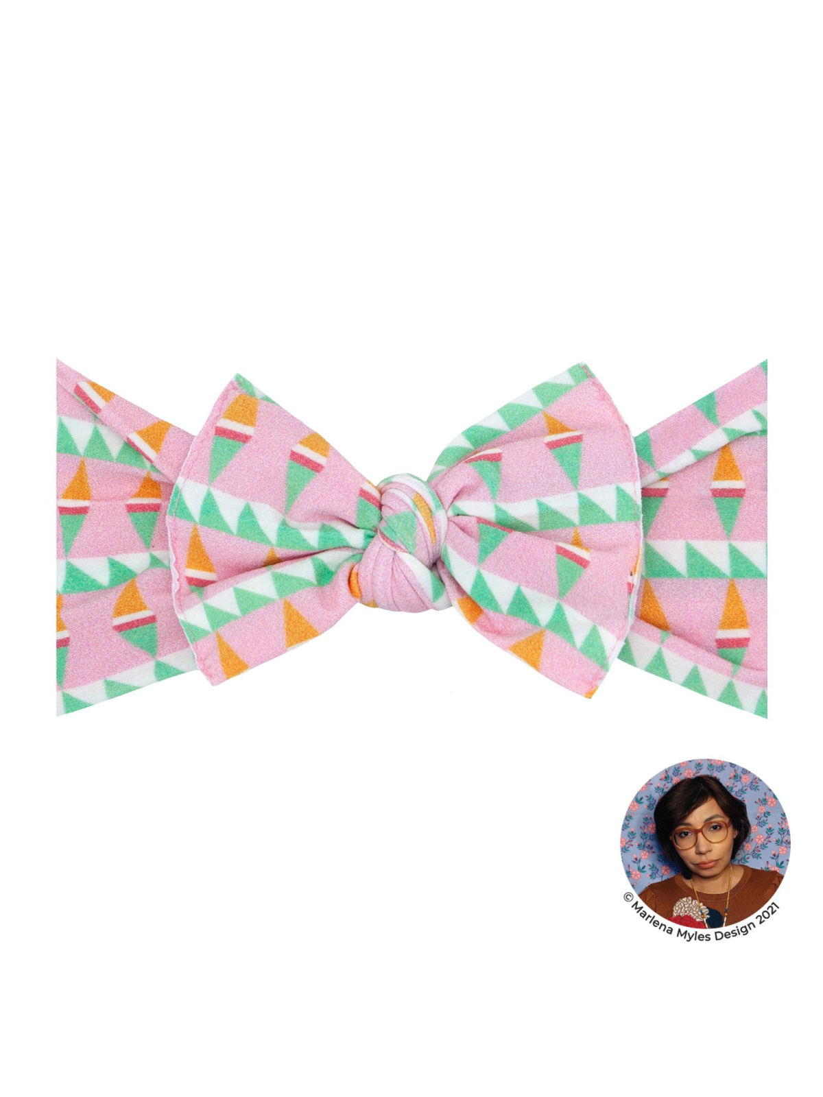 Colorful geometric bow tie with pink, green, and orange patterns on a white background. Designed by Marena Myles.