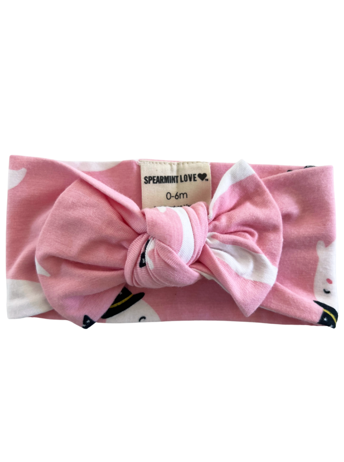 Pink baby headband with a bow, featuring ghost patterns, labeled "Spearmint Love, 0-6m."