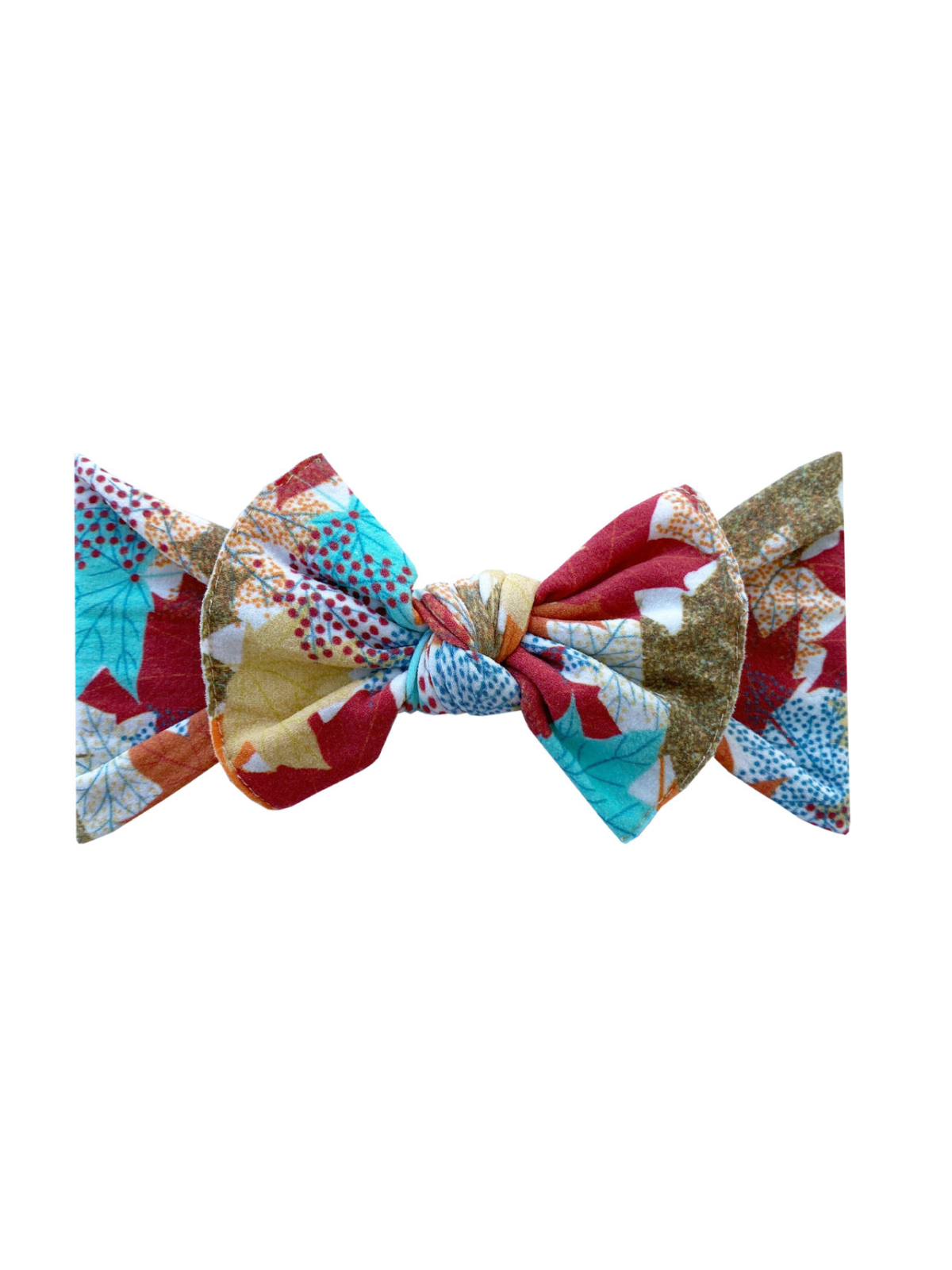Colorful fabric bow with leaf patterns in red, blue, and gold on a white background.