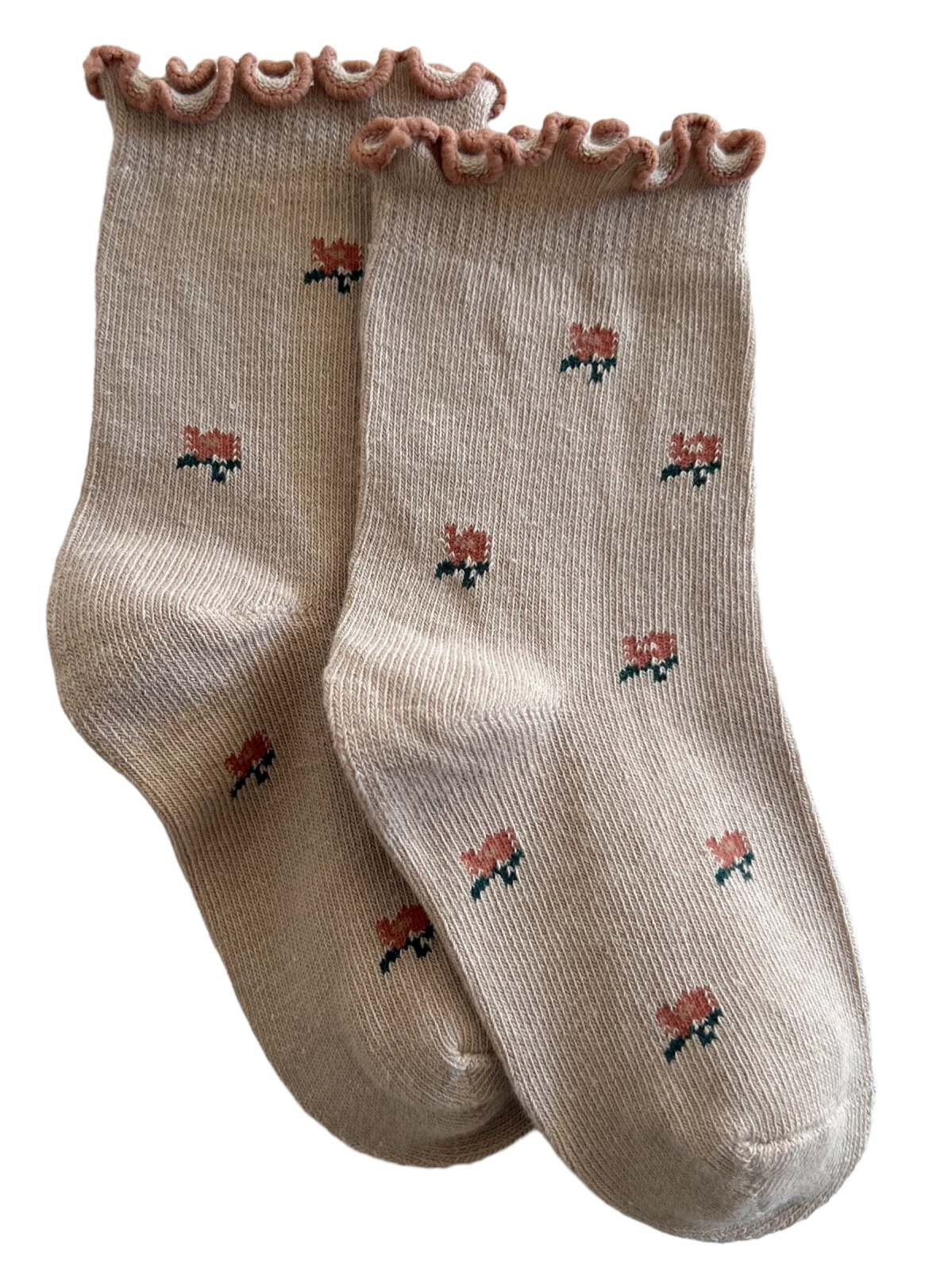 Beige socks with ruffled tops and floral patterns in pink and green. Ideal for cozy and stylish wear.