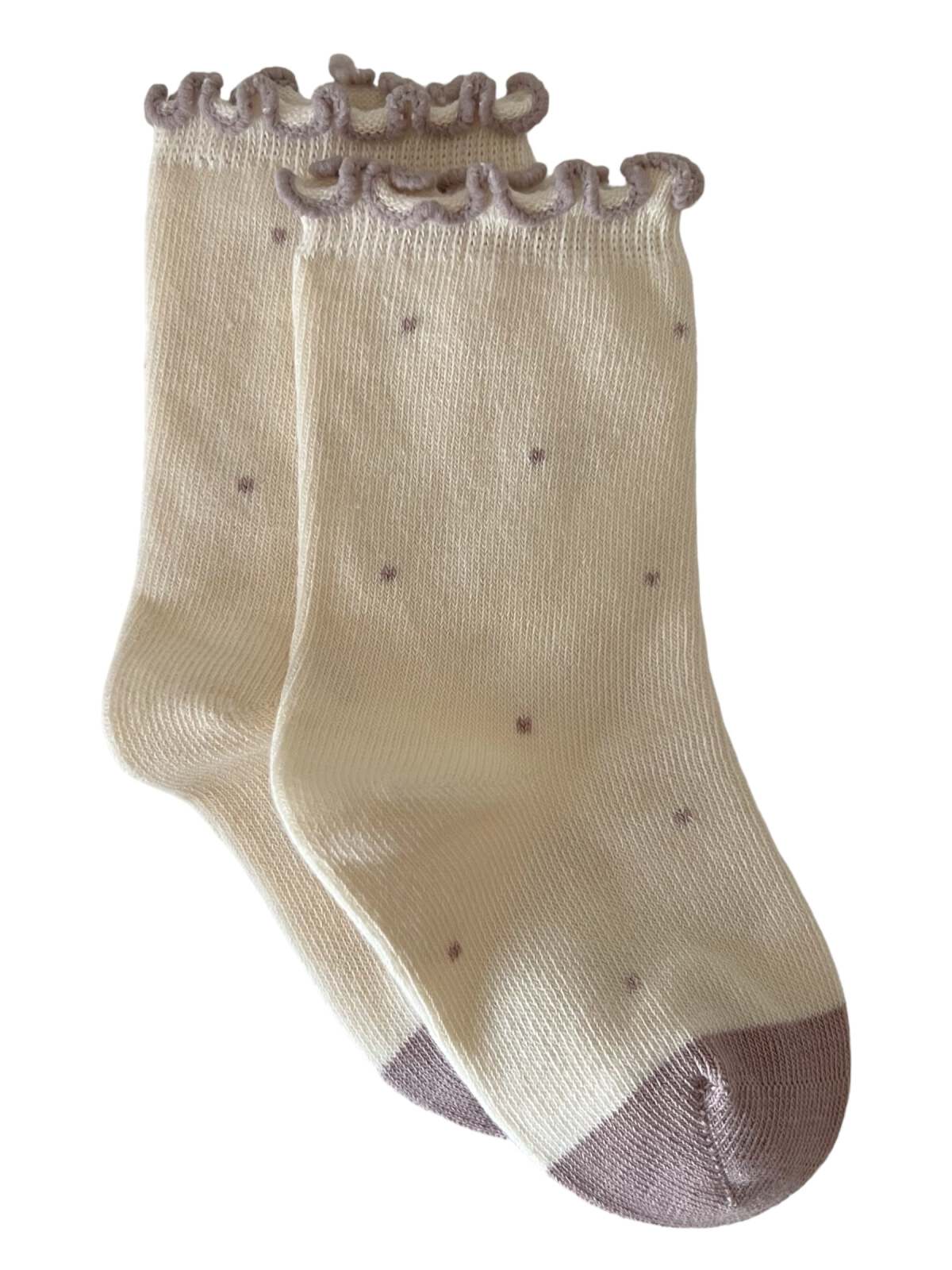 Cream-colored socks with ruffled openings and polka dots, featuring a beige toe.