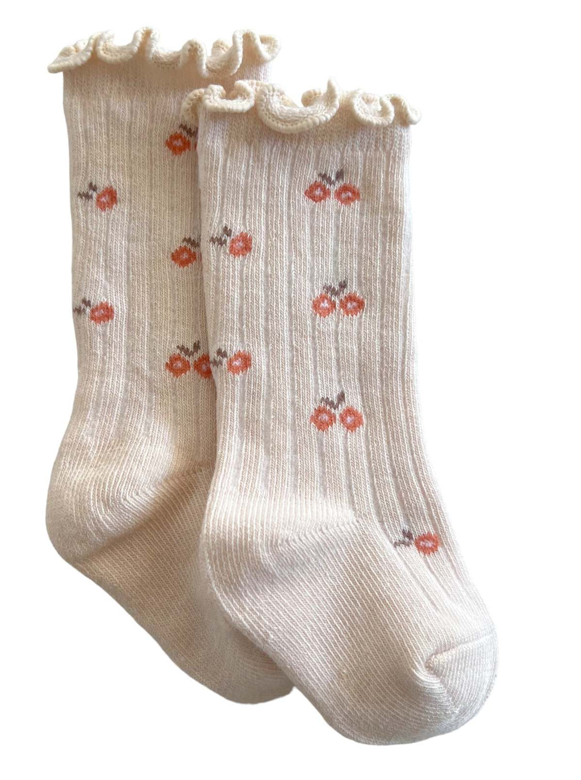 Cream socks with ruffled tops, featuring a cherry pattern in orange and brown.
