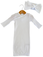 White ribbed dress with long sleeves and a matching bow headband, displayed on a wooden hanger.