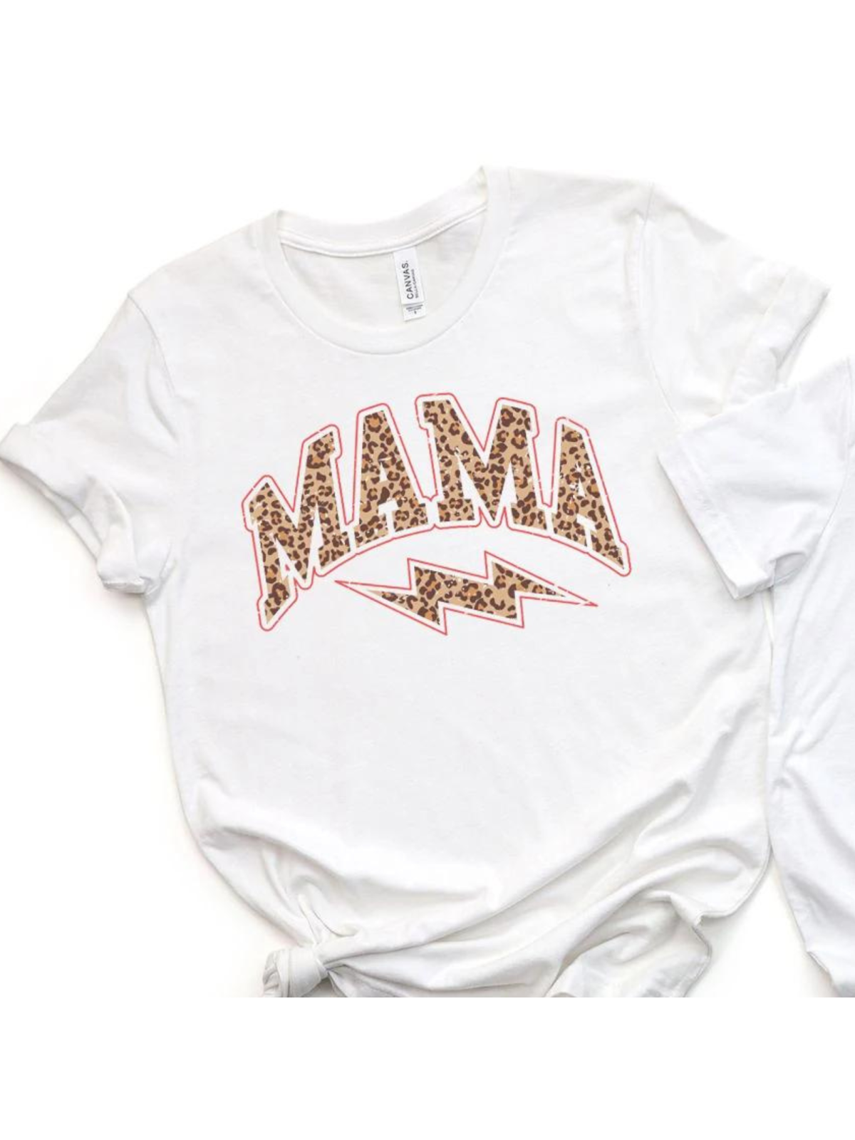 White t-shirt featuring the word "MAMA" in leopard print and lightning bolt design.
