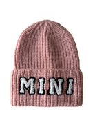 Pink knit beanie with the word "MINI" in white and black, featuring a ribbed texture.