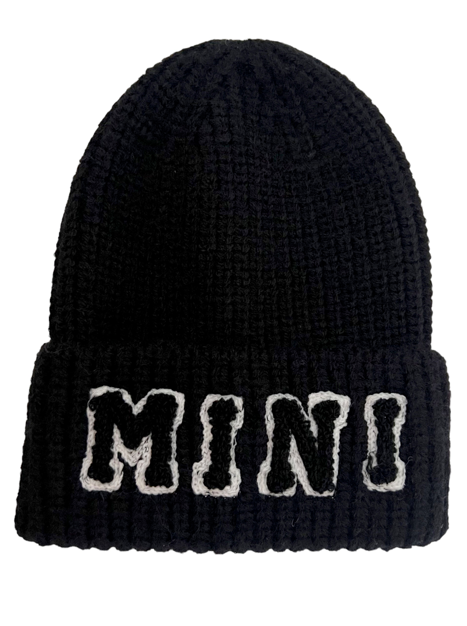 Black knit beanie with white "MINI" lettering on the front. Ideal for winter and stylish casual wear.