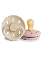 Two pacifiers, one cream and one pink, designed for infants, featuring unique cutouts for airflow.