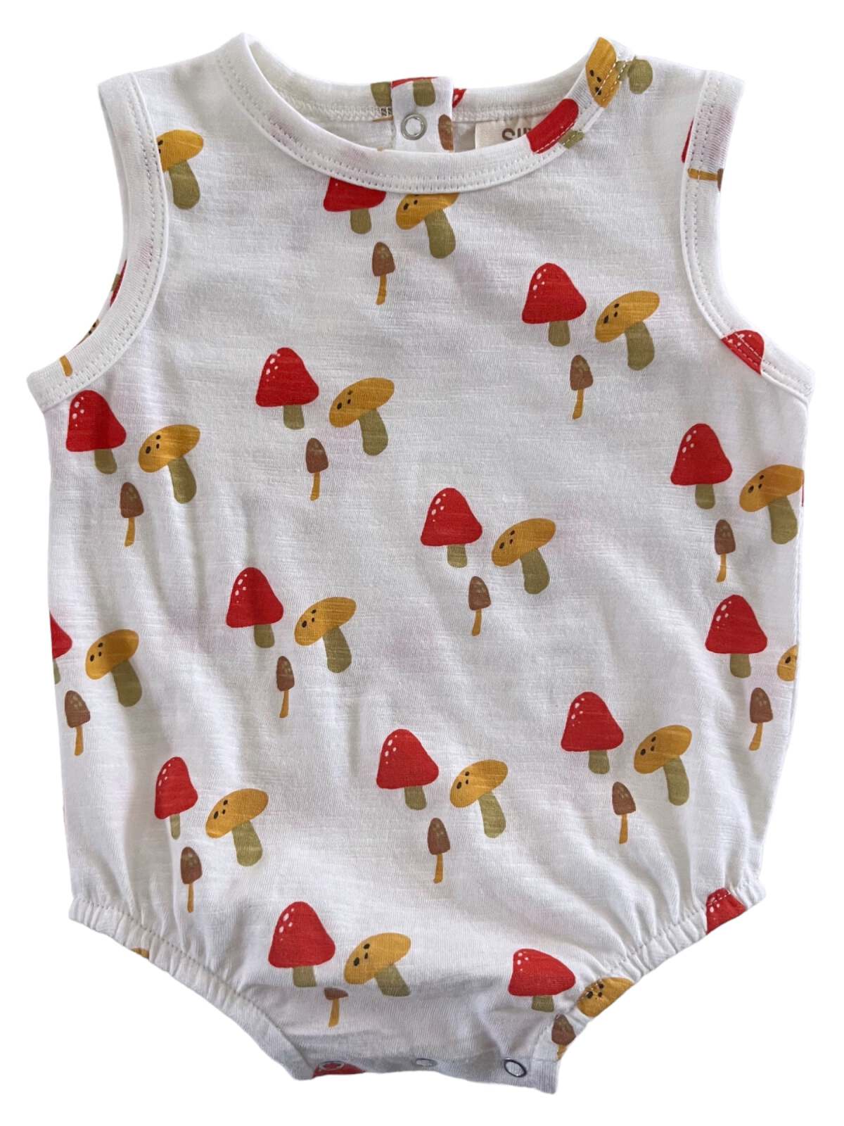 White sleeveless onesie featuring a playful mushroom print in red, yellow, and brown. Perfect for toddlers.