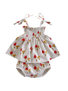 White dress with red and yellow mushroom print, featuring adjustable straps and paired with matching bloomers.