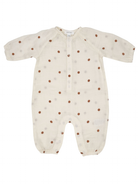 Beige baby onesie with brown polka dots and button-up front, featuring long sleeves and elasticized cuffs.