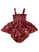 Red floral baby dress with matching bloomer. Features thin straps and a smocked bodice design.