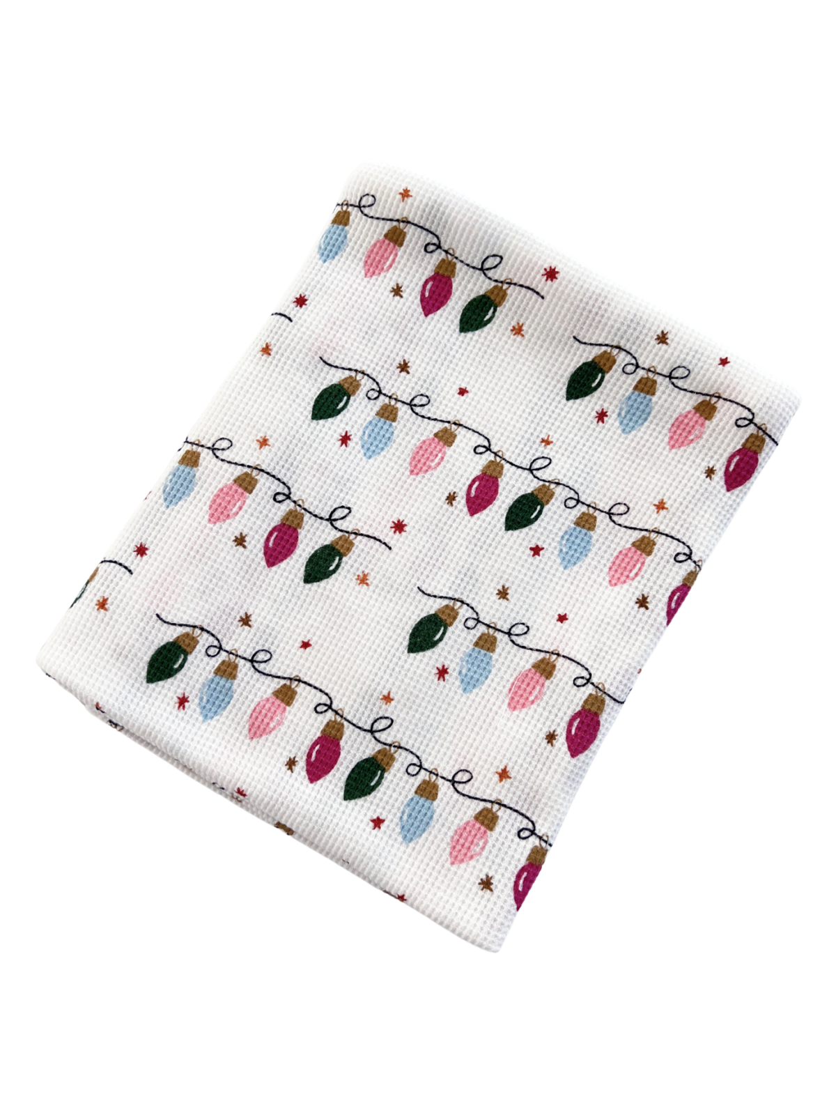 Patterned holiday dish towel featuring colorful Christmas lights and small stars on a white background.