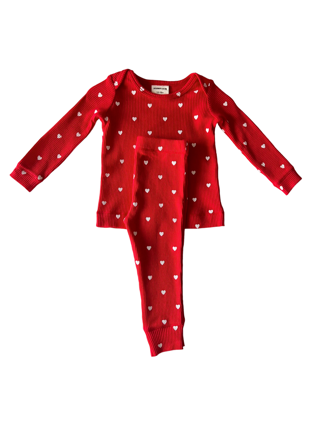 Red long-sleeve pajamas with white heart patterns for children, displayed flat against a white background.
