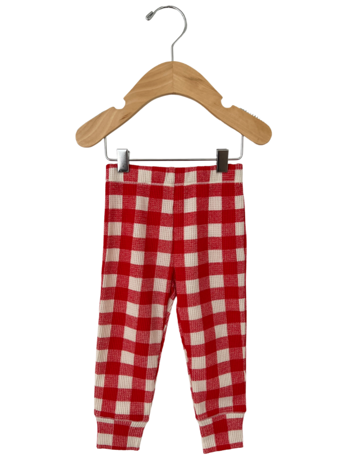 Red and white checkered toddler pants hanging on a wooden hanger.