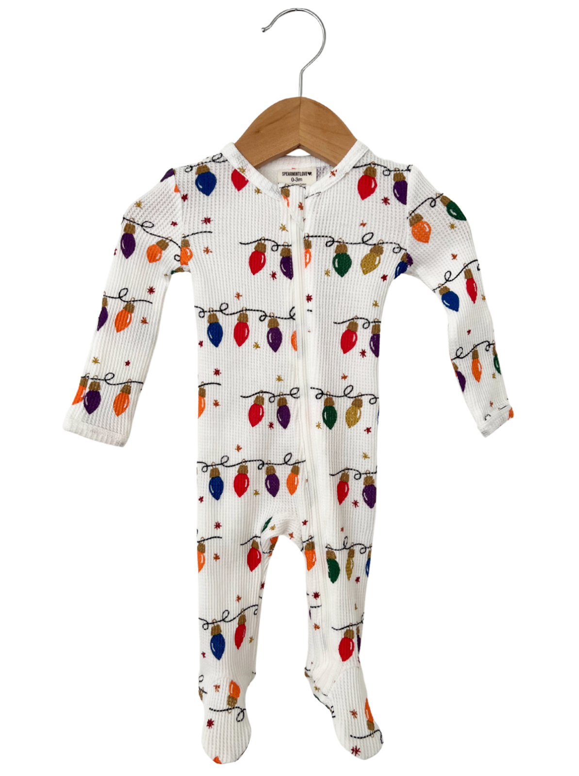 White infant onesie with colorful holiday lights pattern, hanging on a wooden hanger.