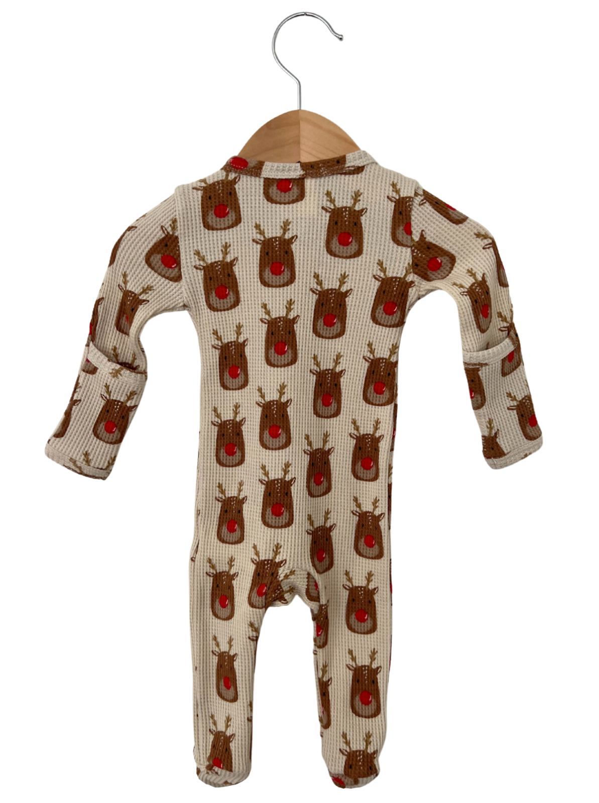 Baby onesie with reindeer print, featuring a soft fabric and long sleeves, hanging on a wooden hanger.