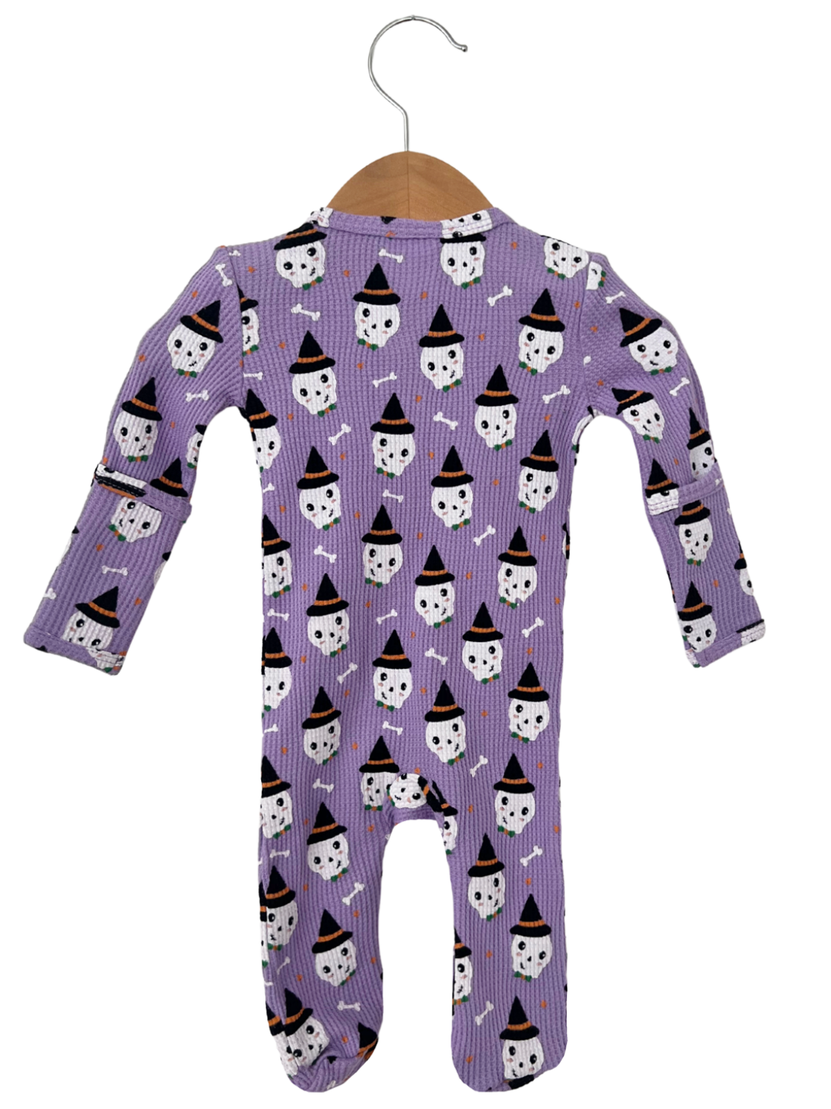 Purple toddler onesie with Halloween ghost and witch hat pattern, hanging on a wooden hanger.