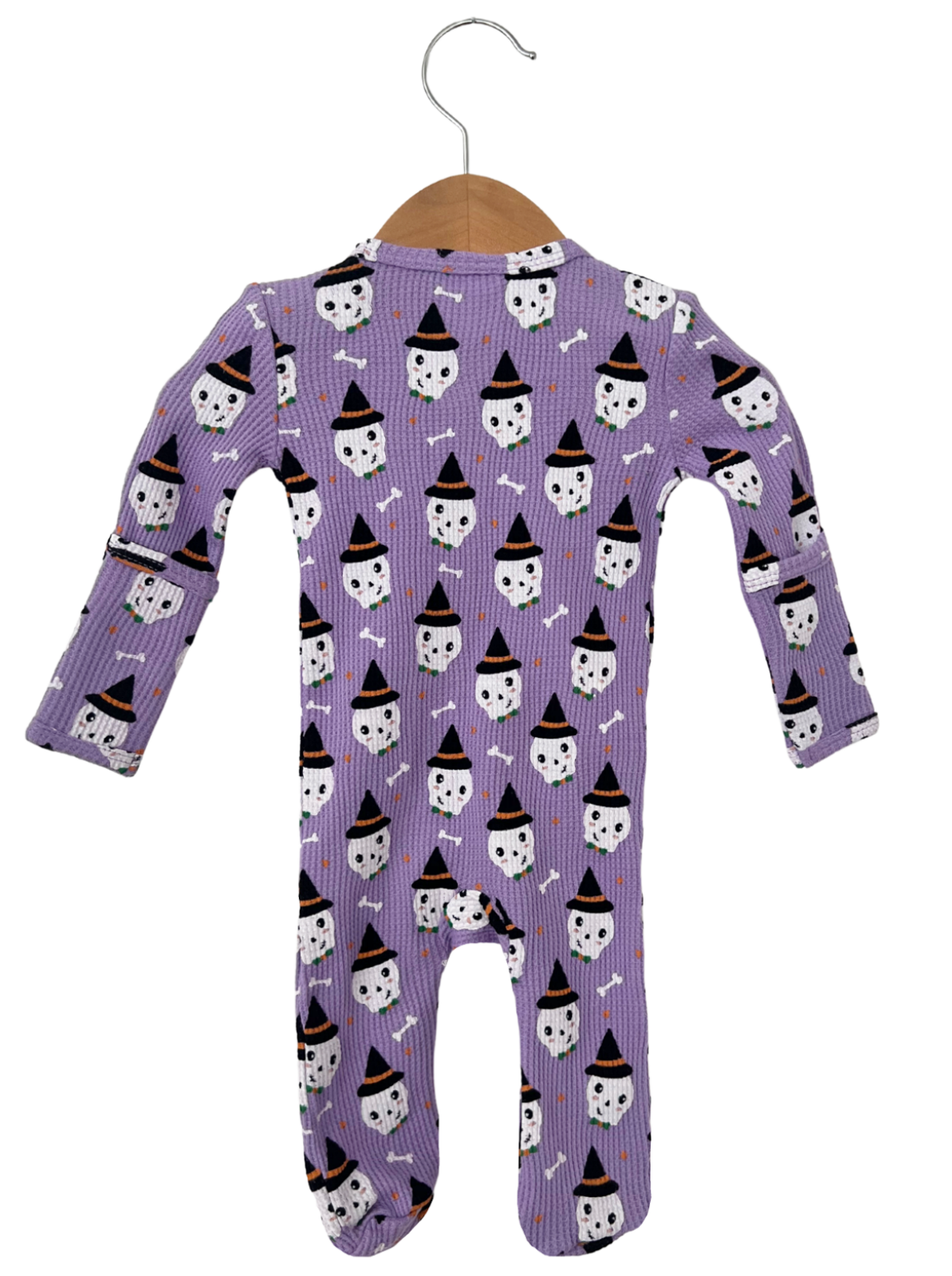 Purple toddler onesie with Halloween ghost and witch hat pattern, hanging on a wooden hanger.