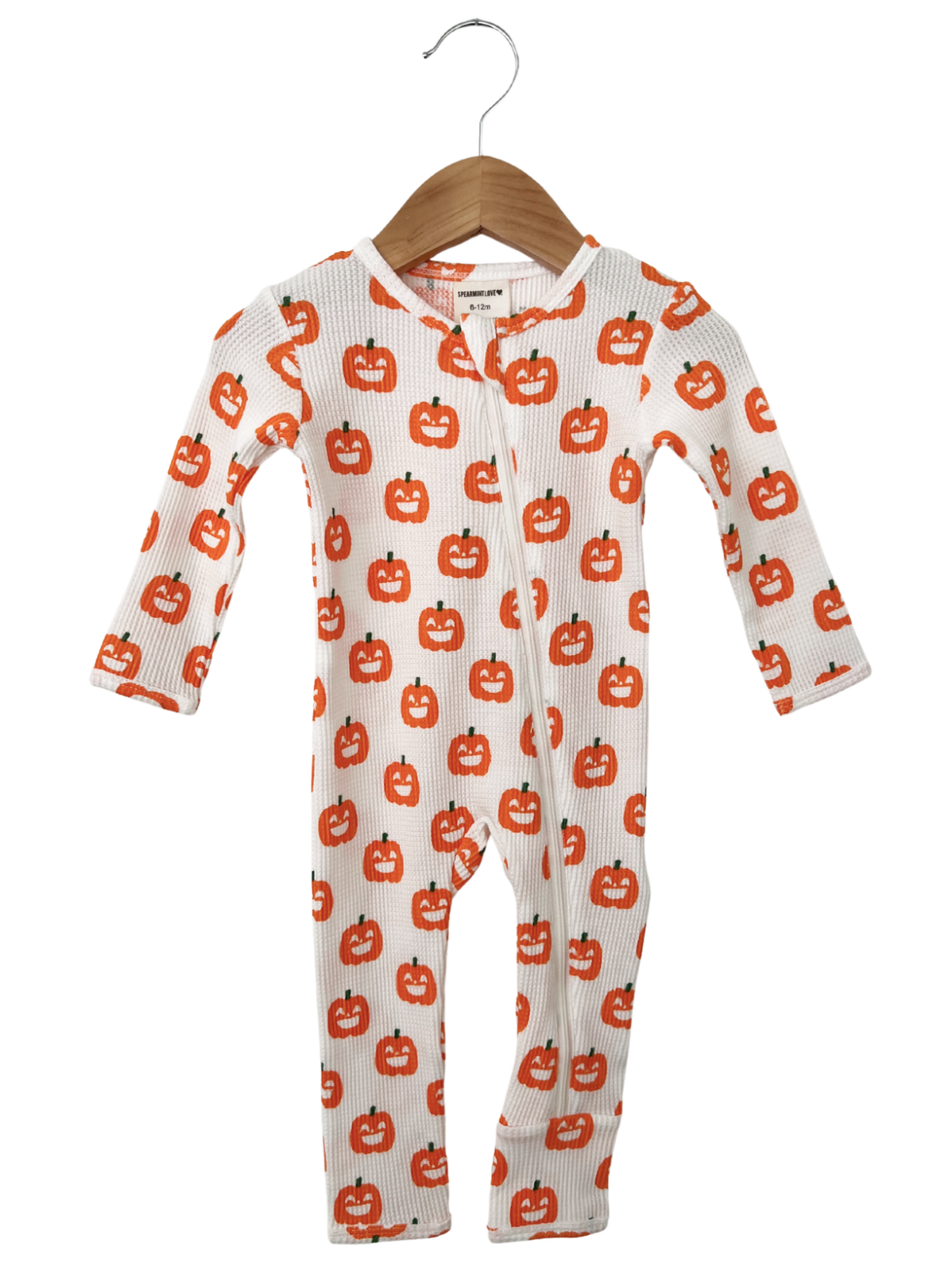 White baby onesie with orange pumpkin print, featuring long sleeves and a zipper front.