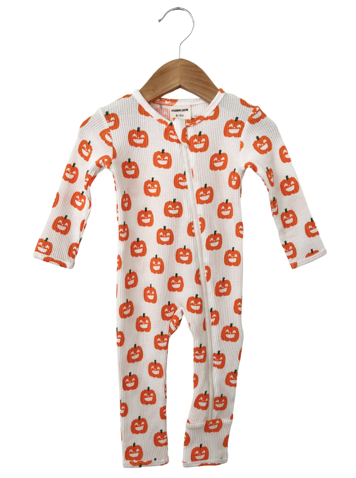 White baby onesie with orange pumpkin print, featuring long sleeves and a zipper front.
