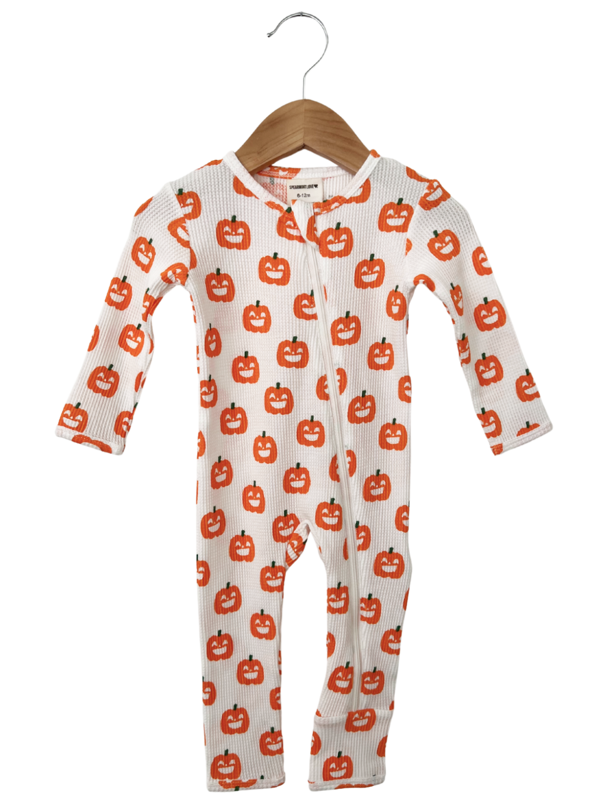 White baby onesie with orange pumpkin print, featuring long sleeves and a zipper front.