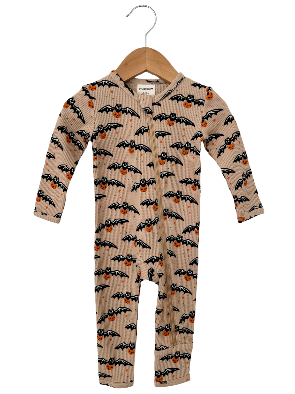 Infant onesie with bat and pumpkin print, featuring a hood and zipper, hanging on a wooden hanger.