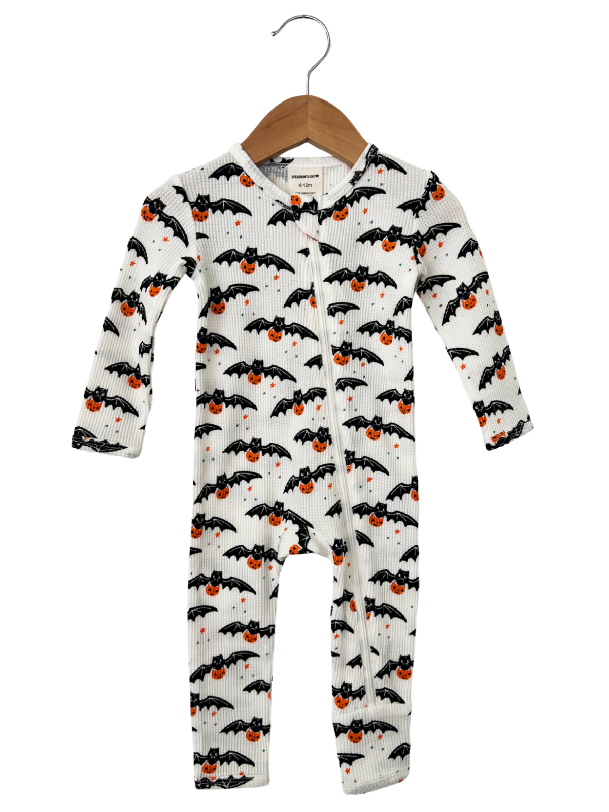 Baby onesie with bat and pumpkin pattern, hanging on a wooden hanger, suitable for Halloween.