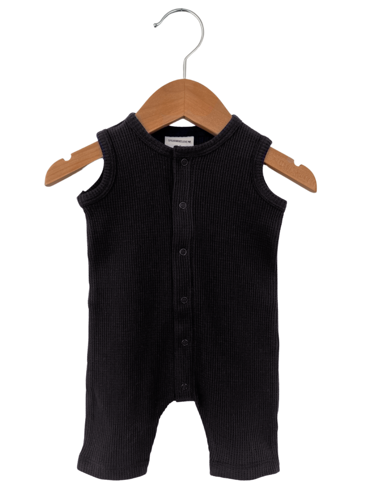 Black ribbed baby onesie on a wooden hanger, front view with snap buttons.