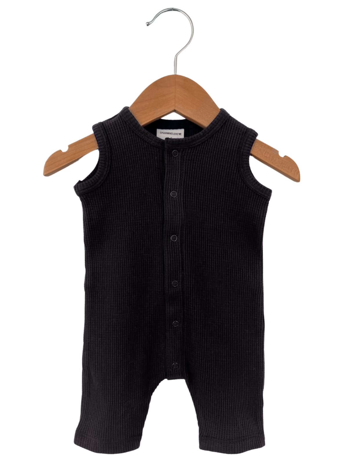 Black ribbed baby onesie on a wooden hanger, front view with snap buttons.