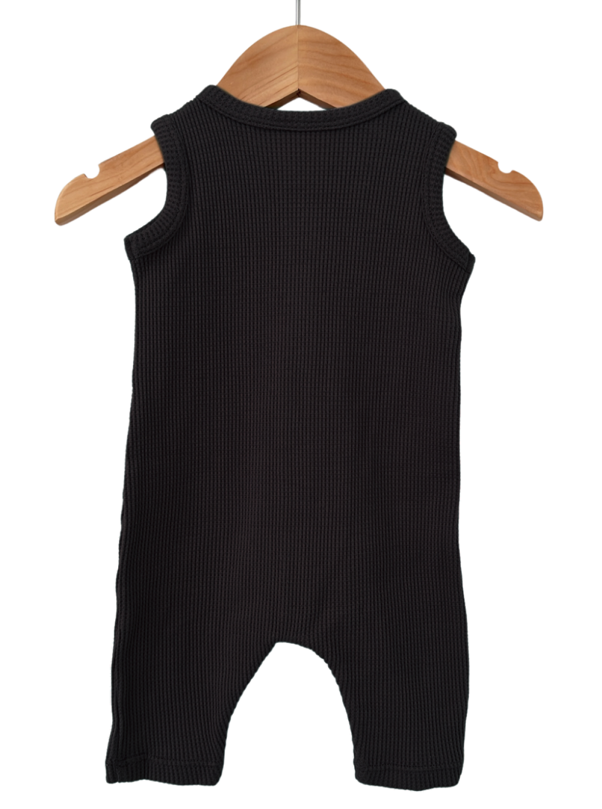 Black sleeveless ribbed baby romper hanging on a wooden hanger against a white background.