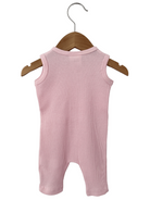 Pink ribbed onesie hanging on a wooden hanger against a white background.