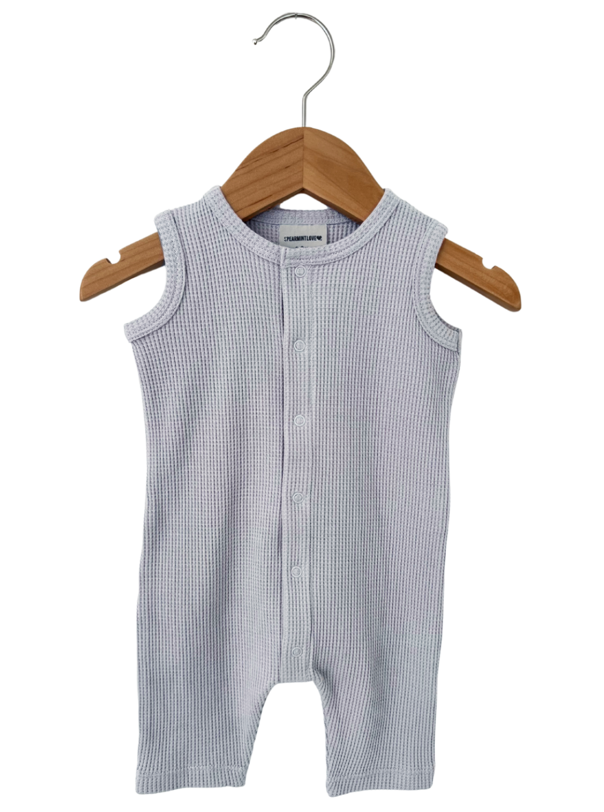 Light gray cotton baby romper on a wooden hanger, featuring a button-up front and sleeveless design.