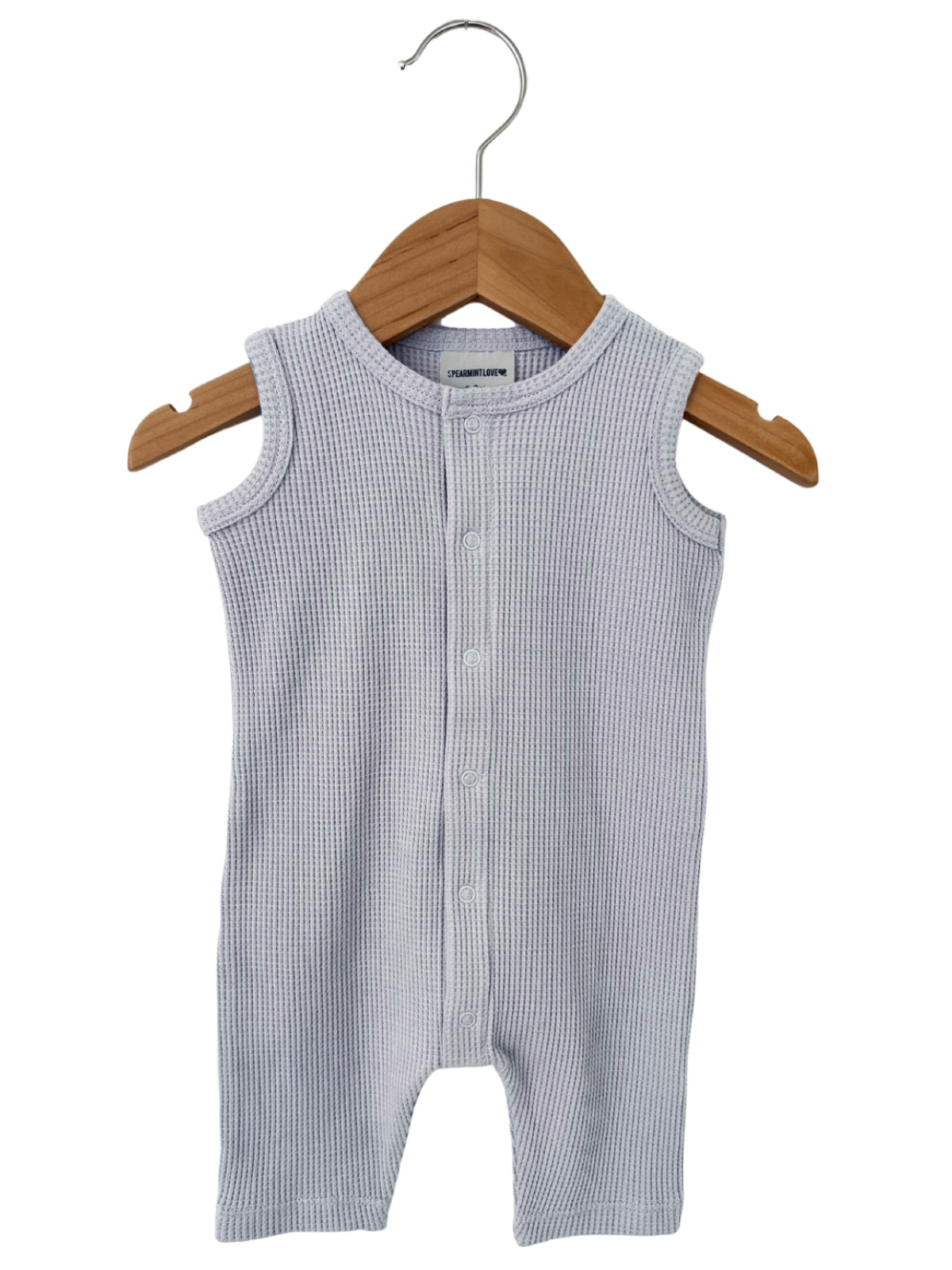 Light gray cotton baby romper on a wooden hanger, featuring a button-up front and sleeveless design.