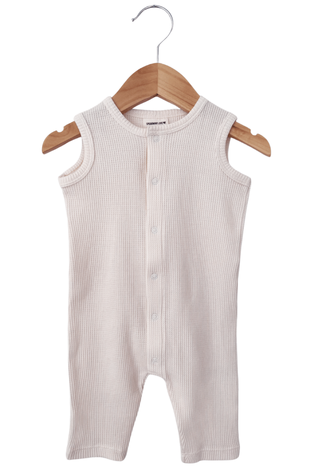 Light beige ribbed baby romper hanging on a wooden hanger against a white background.