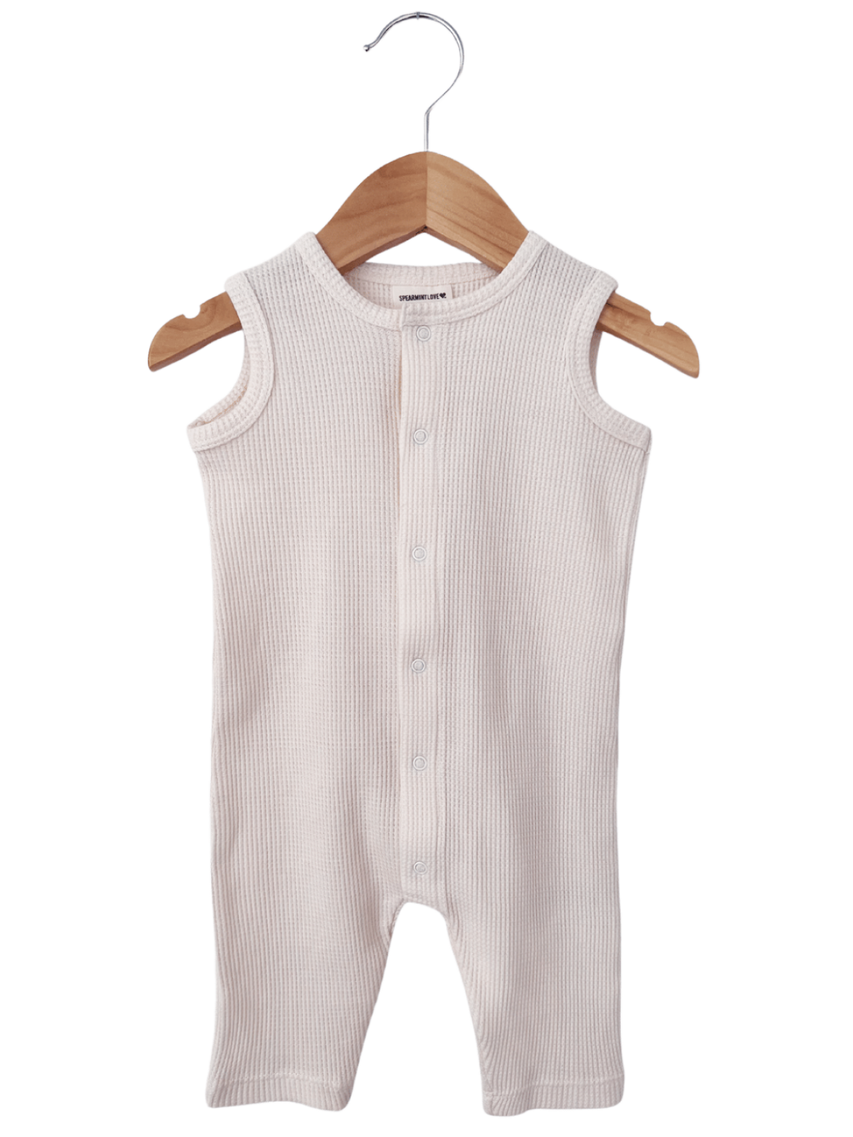 Light beige ribbed baby romper hanging on a wooden hanger against a white background.