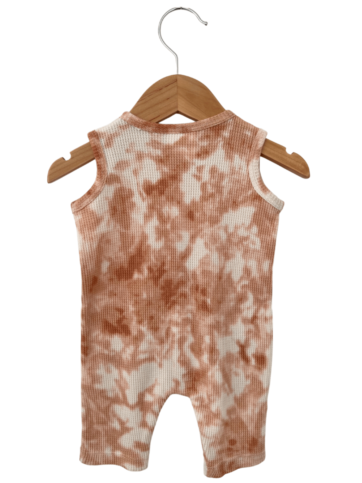 Back view of a sleeveless baby romper hanging on a wooden hanger, featuring a tie-dye pattern in peach and white.