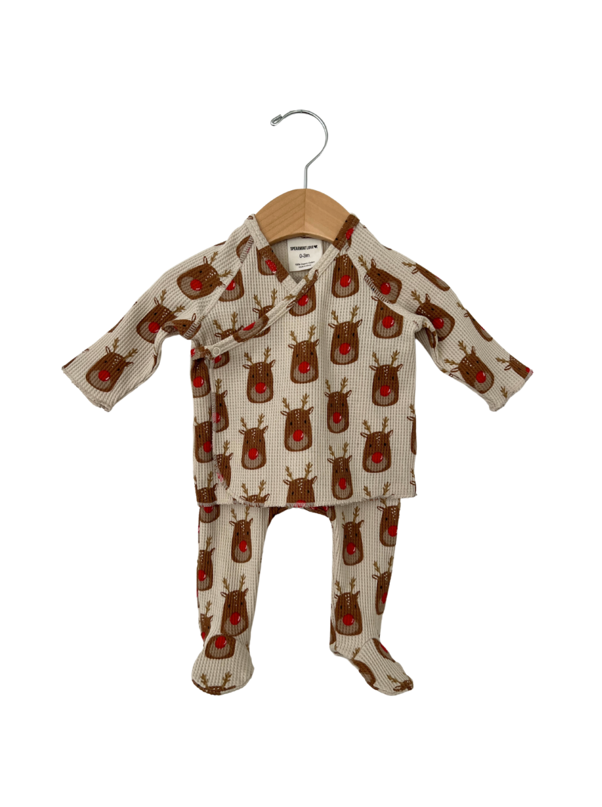 Child's cozy outfit featuring a reindeer print, displayed on a wooden hanger against a white background.