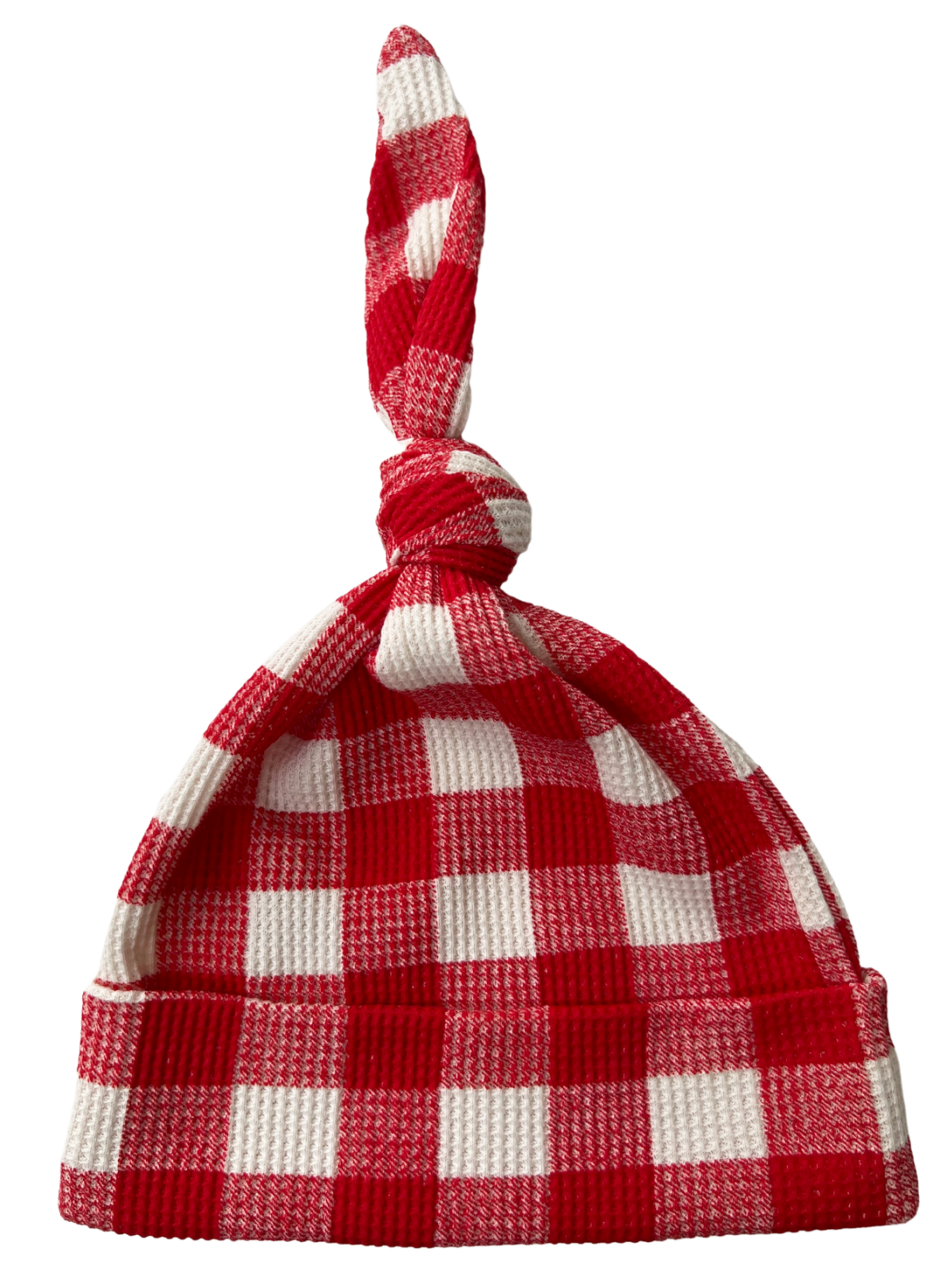 Red and white checkered beanie hat with a knot on top, folded at the brim.
