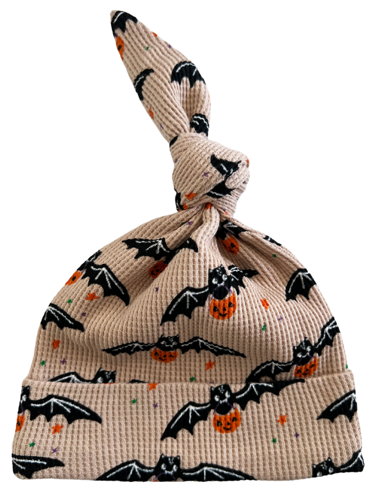 Knotted baby hat with bats and pumpkins on a light background, perfect for Halloween-themed outfits.