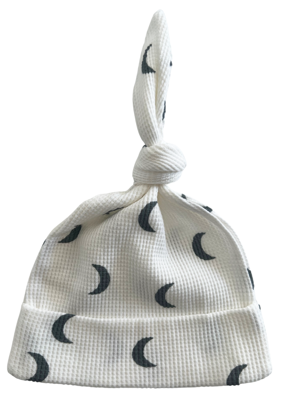 White hat with moon print and a knot on top, perfect for infants or young children.