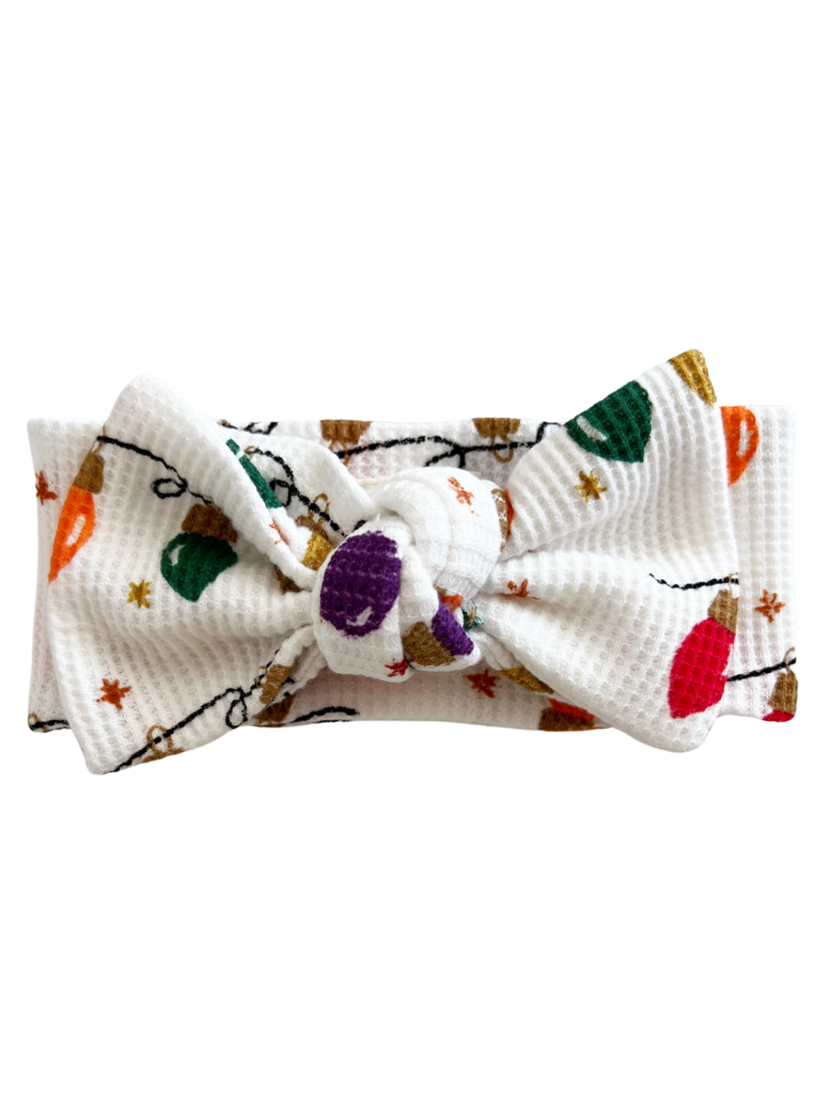 White headband with a knot, featuring colorful holiday lights pattern and stars.